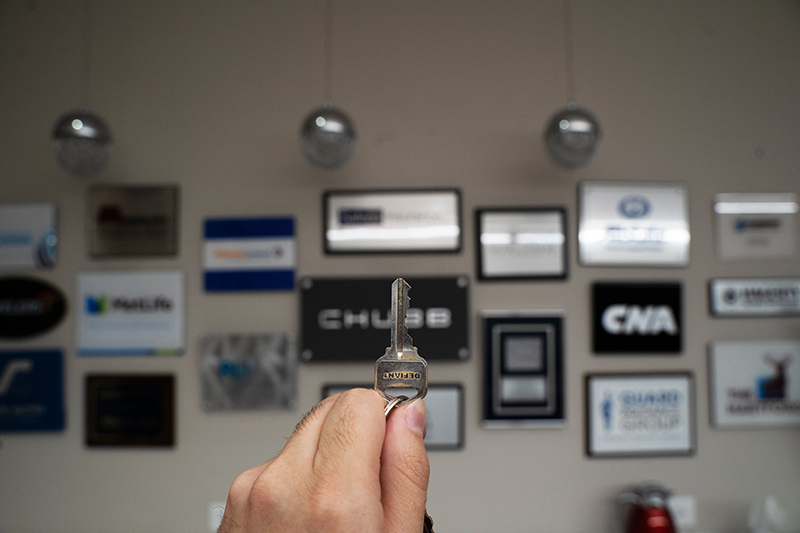 person's hand holding up a key