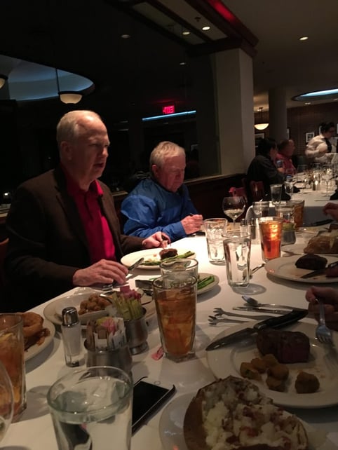 two men eating dinner 